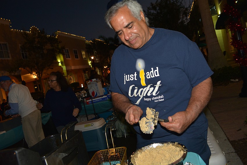 Yoav Cohen prepares falafels, made of ground chickpeas and spices.