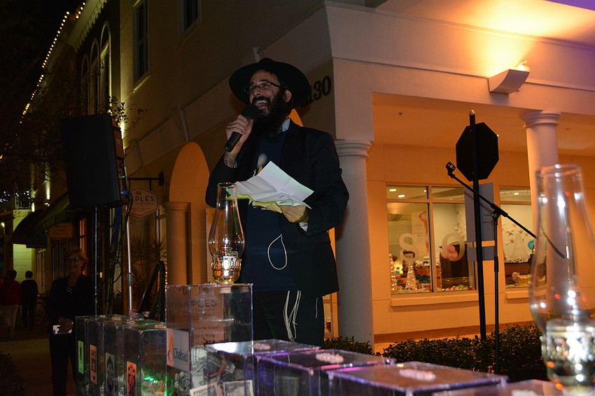 Chabad of Bradenton and Lakewood Ranch Rabbi Mendy Bukiet welcomes guests before launching into song.