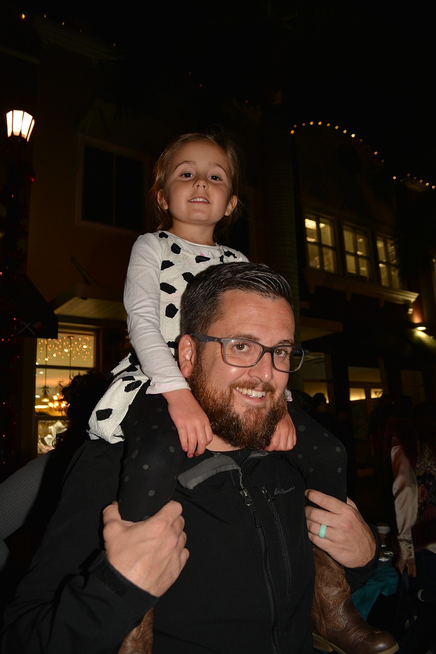 Rachel Taylor, 5, gets a birds-eye view from the shoulders of her father, Jacob.