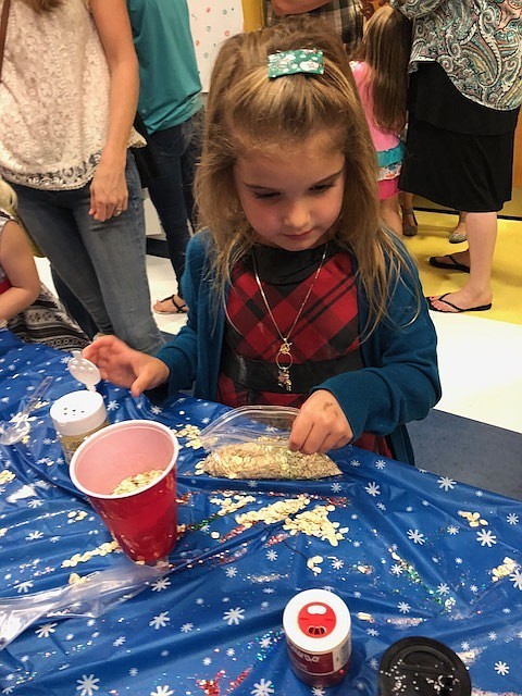 Emerson Trusz makes reindeer food during the Cookies with Santa event. Courtesy photo.