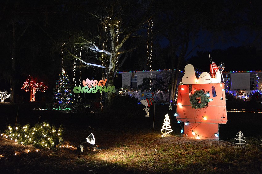 The scene in front of Mike Wilder’s Braden Woods home at 9920 65th Ave. E.is a tribute to “A Charlie Brown Christmas.”   (Photo by Pam Eubanks).