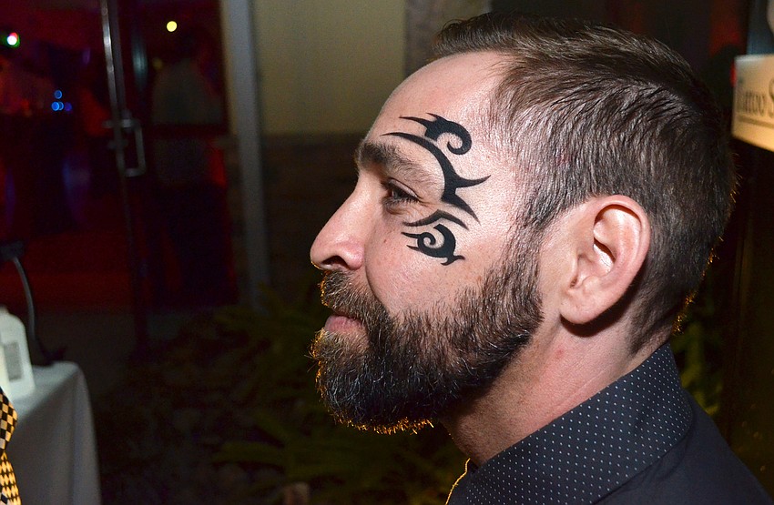 Robin Howe shows off his new Mike Tyson airbrush tattoo at Troupe Gala on Feb. 3.