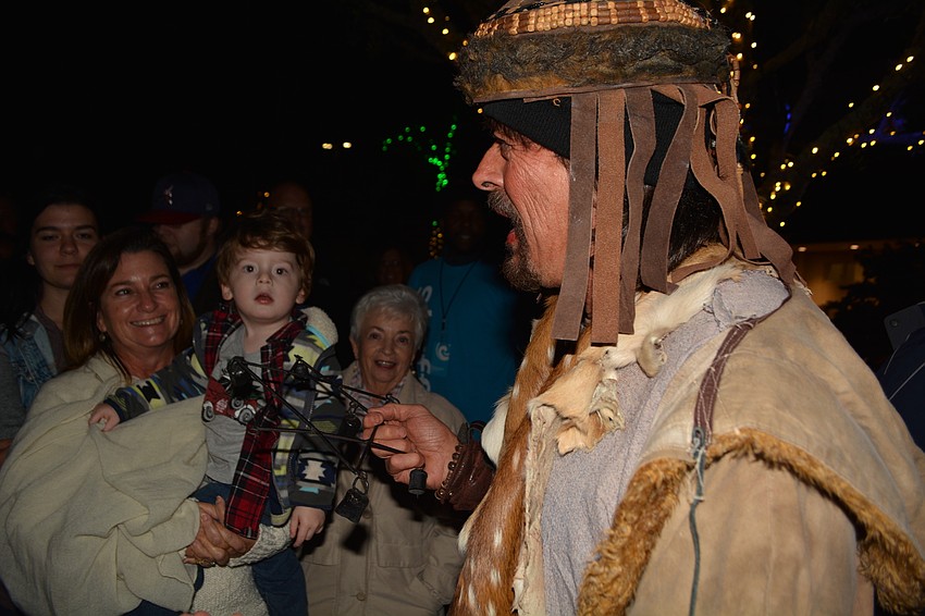 Lisa Arfrons, holding her grandson Gattis Snipes, laughs as actor Mike Graham tries to get the crowd to respond. 