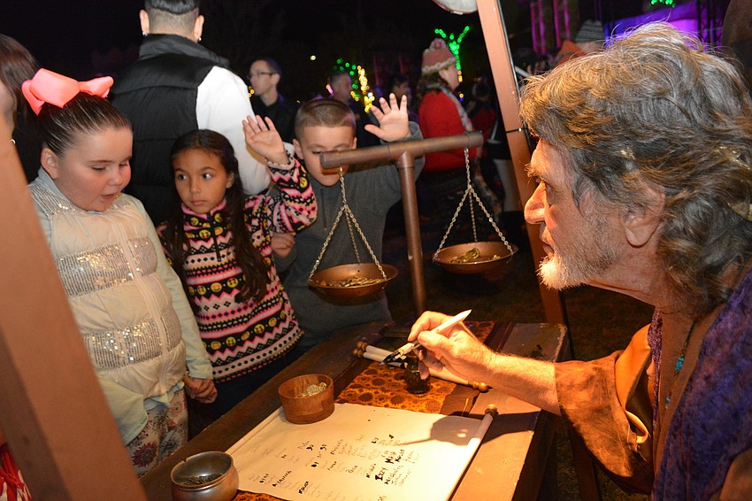 Braden River Elementary students Jaylen Robarge, left, and Audrianna Alicea, center, add their names to the census, being taken by actor Chuck Detore.