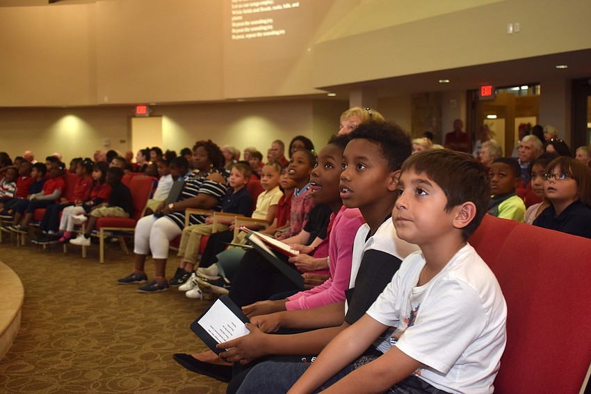 Students from the 13th Avenue Dream School sing along during a service at Christ Church.