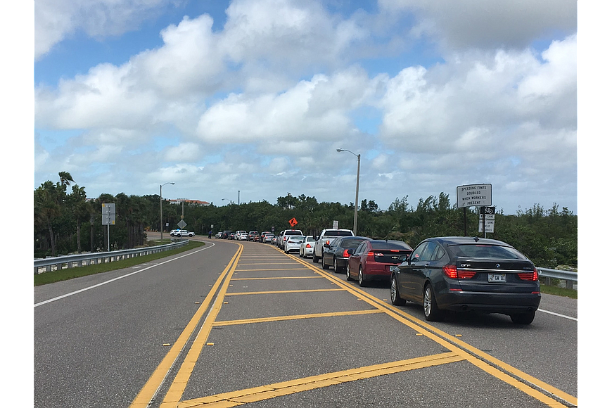 Cars waited in line to re-enter the island.