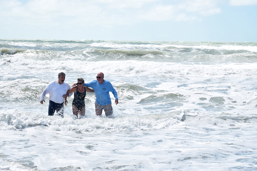Fred Lugano, Carol Miller and Rudy Schippers test out the waters of the Gulf of Mexico on Longboat Key. The trio did not evacuate Longboat Key during Hurricane Irma.