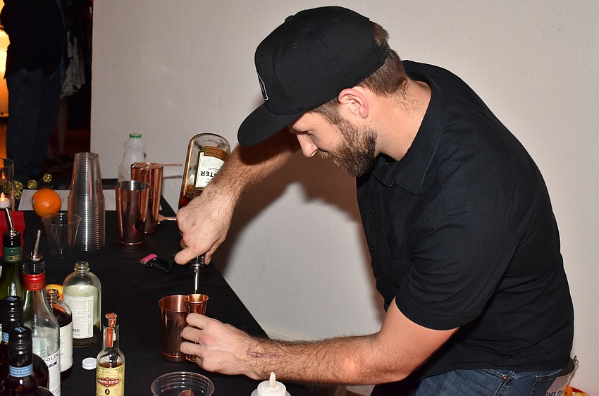 Joey Stark of Social Eatery & Bar shakes a whiskey concoction.