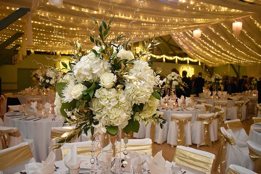Each table was adorned with a white floral centerpiece.