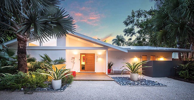 The strict geometry of the homeâ€™s faÃ§ade is enlivened by tropical plants. The home is thought to be the work of Ralph and William Zimmerman, father and son architects of the Sarasota School.