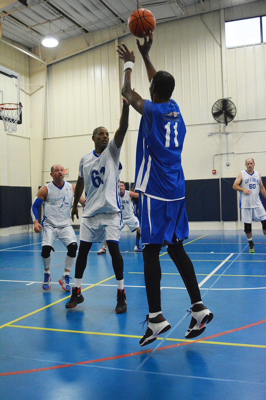 May 8: Brian Speight tries to block a John Edwards shot, but misses. Both men play in The Bunker League, a well-respected men's basketball league in the area run by Dennis Bunker.