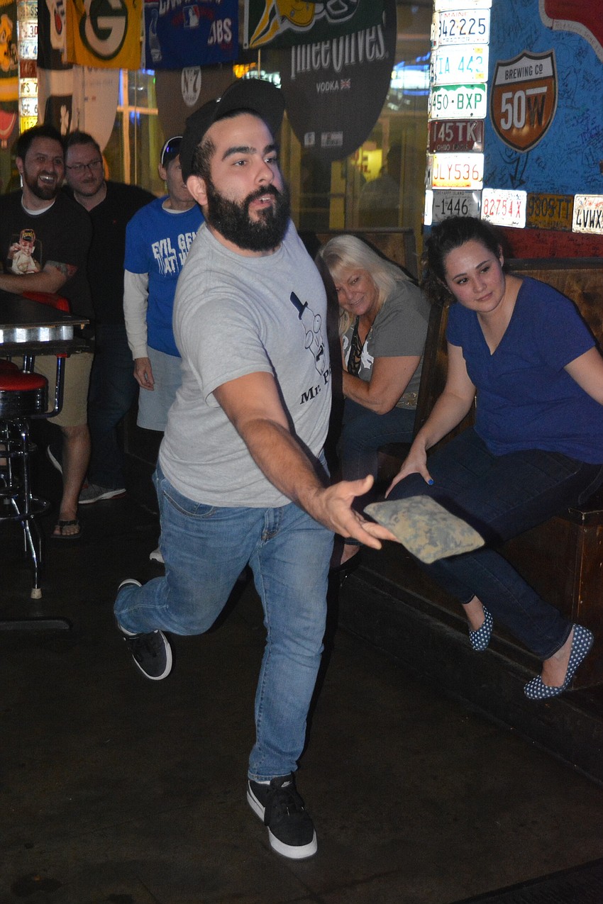 June 27: Gabe Hernandez fires a bean bag during a round of cornhole at Old School Bar and Grill. The game is harder than it looks, he said, especially indoors.