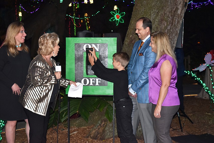 Selby President and CEO Jennifer Rominiecki, Linda Carson and Mike and Jena Wilson watch Hays Wilson turn on the holiday light display.