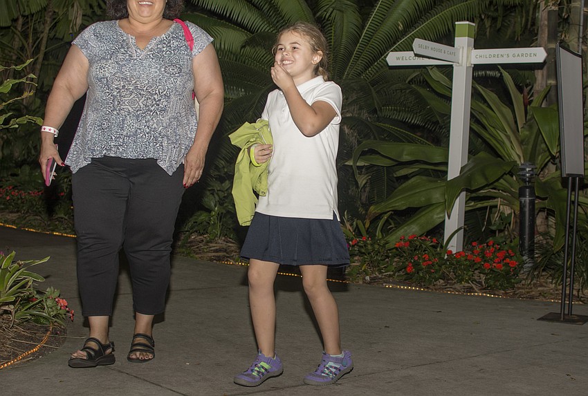 Isabella Smith reacts to seeing the vendors and light display at Selby Gardens on Dec. 20.