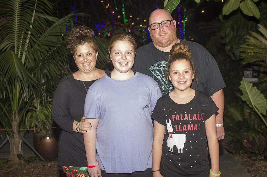 Heather, Ella and Josh Mitchell pose with Ava Barnes before enjoying Selby Gardens Lights in Bloom display.