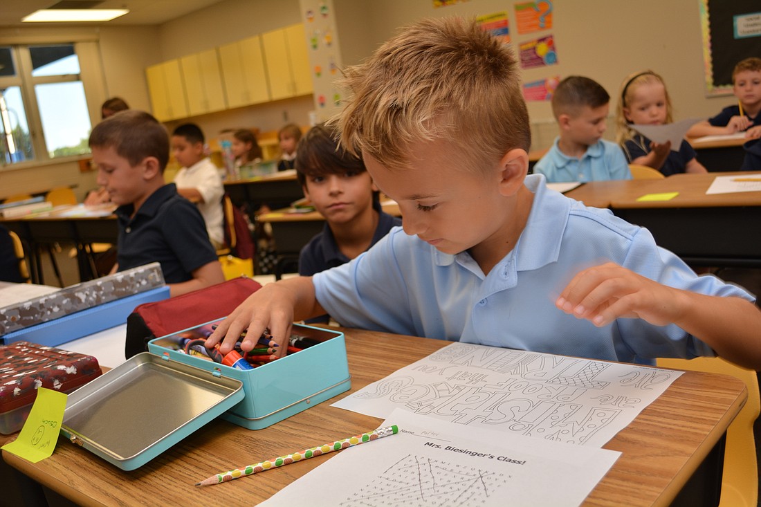 Porter Osuch, a third-grader, colors on the first day of school in August at Willis Elementary. Willis is one of several East County schools  at which the School District plans to add more classrooms. File photo.
