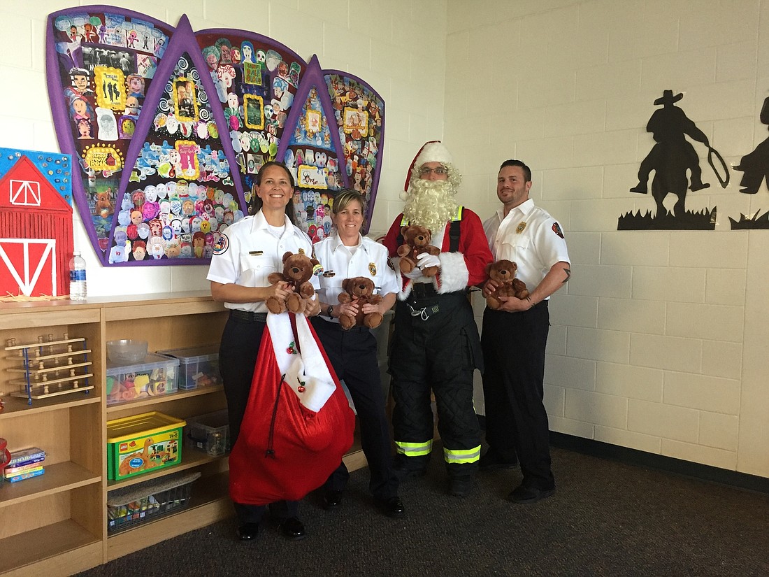 Members of the Longboat Key Fire Association visited Oak Park School to pass out teddy bears. Courtesy photo.