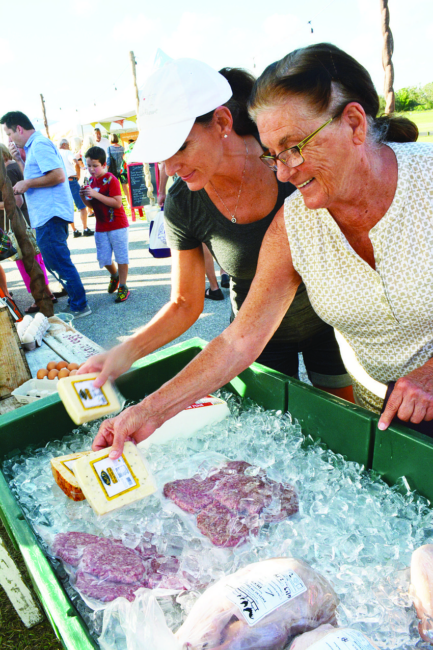 Cincinnati's Bonnie Burchwell, left, and Lakewood Ranch's Kim Grimme check out selections at the new market at Lakewood Ranch, which opened Dec. 6.