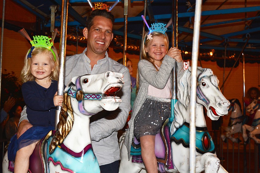 Stella, Blake and Emma Hartshorn enjoy the carousel.