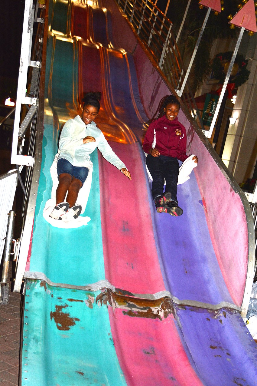 Amya Bryant and Valeria Howard slip down the super slide.