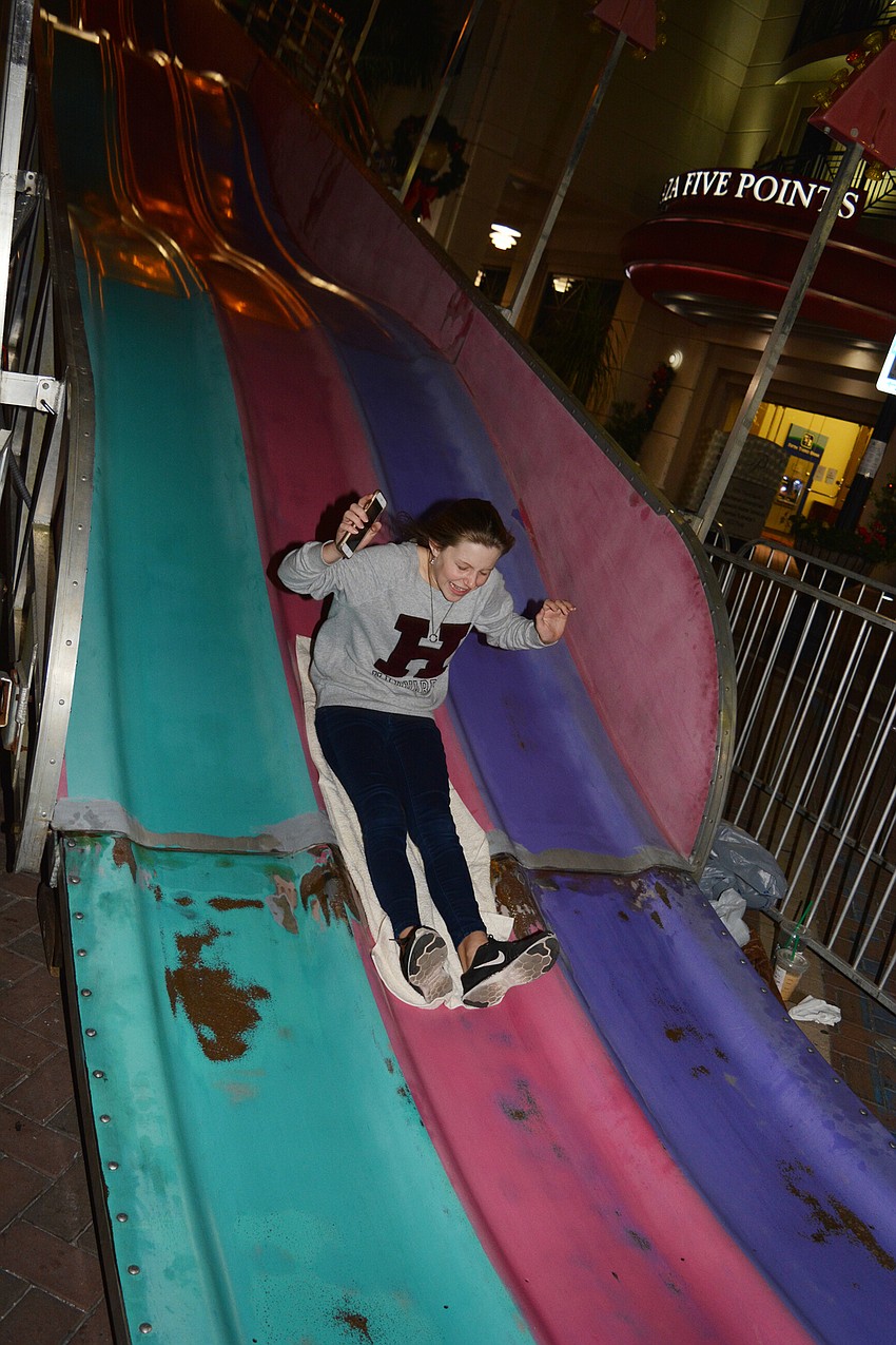 Evelina Gardner zooms down the super slide.