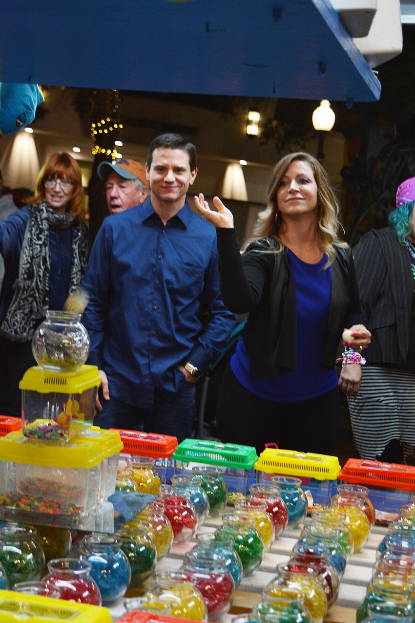 Jim Coppola and Rosa Brown attempt to win a prize at one of the game stands.