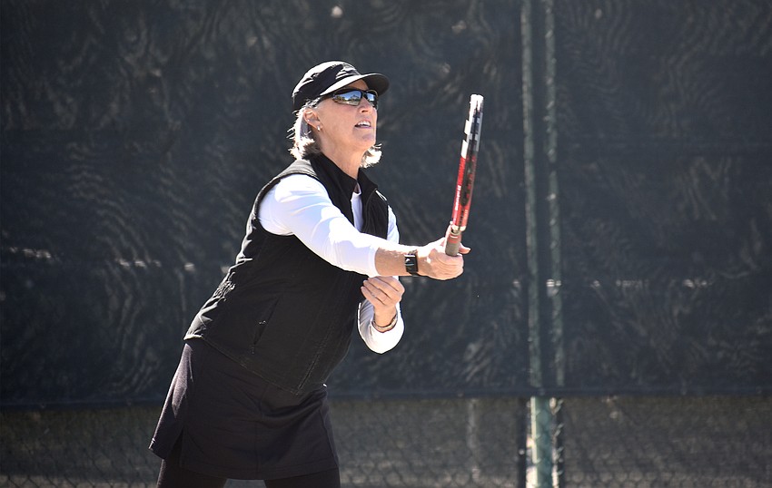 Jan Withers hits the ball during a preliminary match.