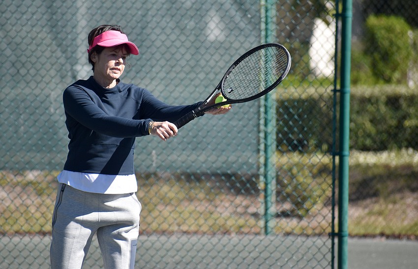 Janice Bini serves the ball in preliminary match.