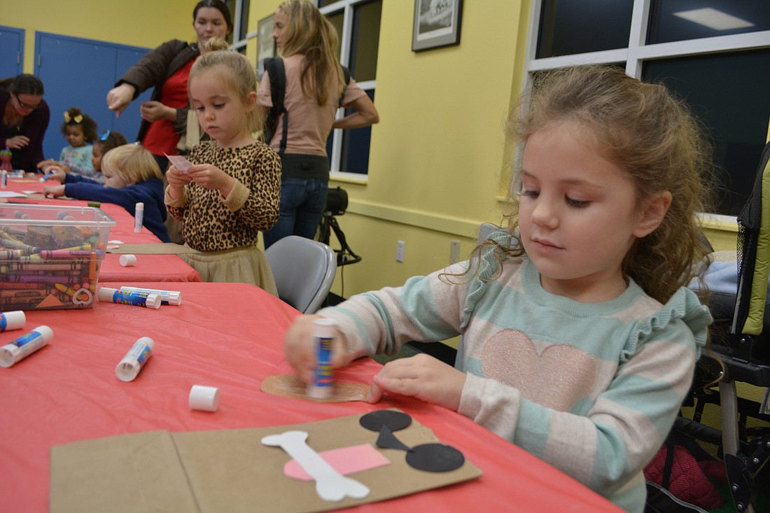 Three-year-old Emily Mercurio, of Central Park, makes a craft after story time at the Braden River Library Jan. 2.