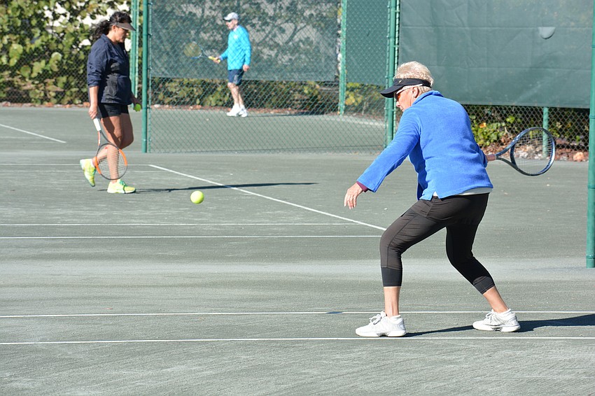 Cathy Powell returns a serve during the Division 2 mixed doubles match.