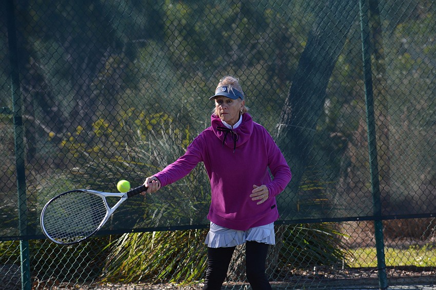 Ute Vela returns a serve with her forehand.