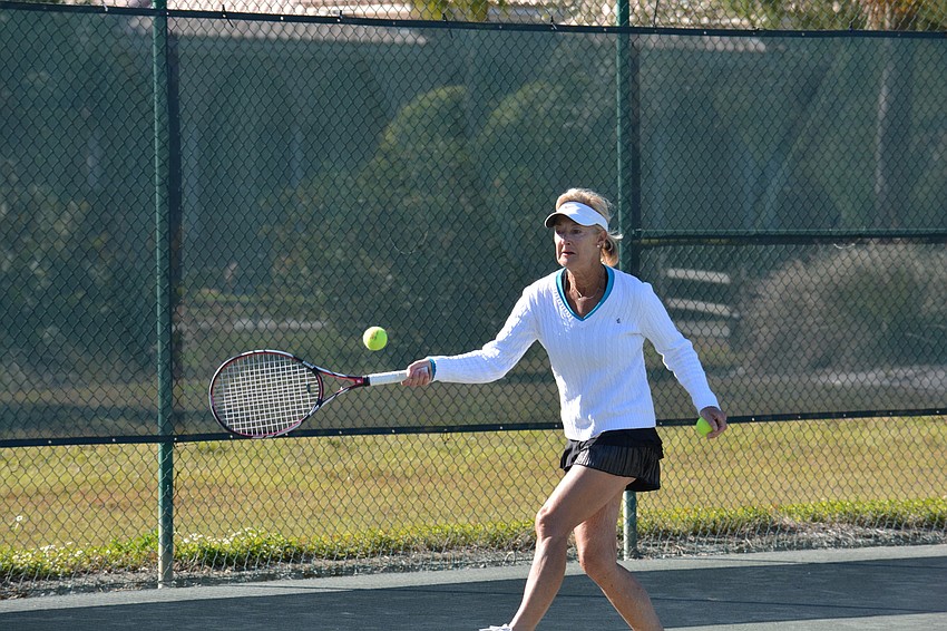 Linda Gillott returns a forehand shot in the Division 2 women's singles match on Sunday.