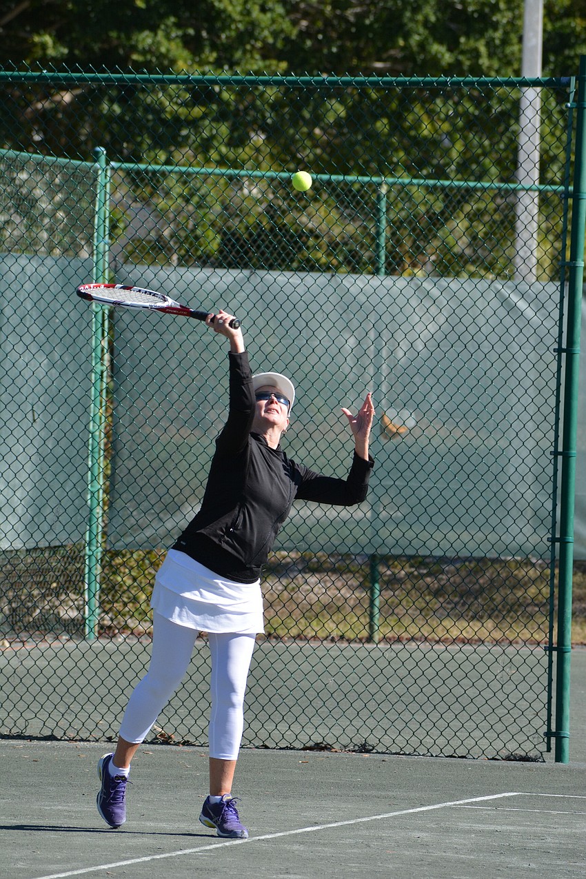 Irene Langlois serves up a point in a Division 3 match Sunday.