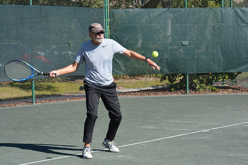 Fred Berg returns a serve in his Division 3 match Sunday.