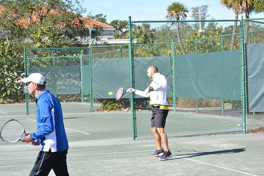 Chris Wetzig returns a service.