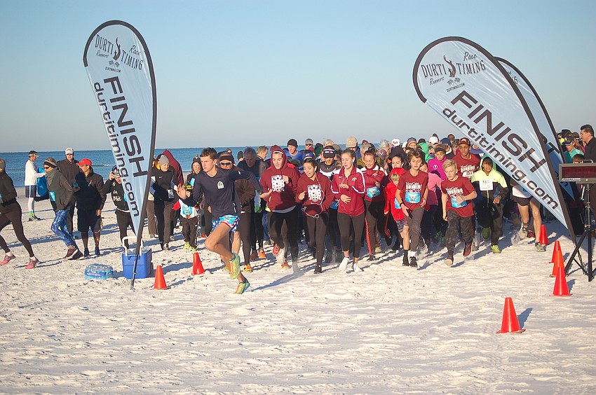And they're off: Participants in the Andrew Monroe Memorial 5K take off down the beach on Siesta Key.