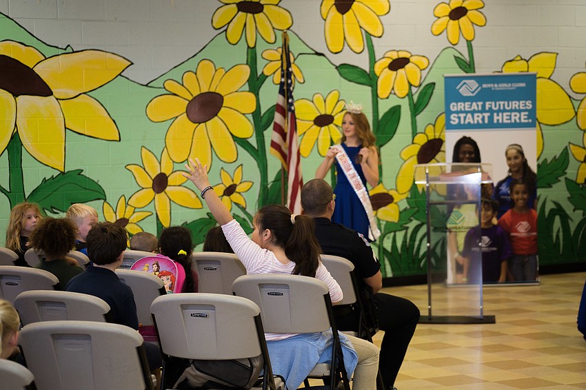 Maddy Boehm asks for children in the audience to help with her presentation, promising candy for those who volunteer.