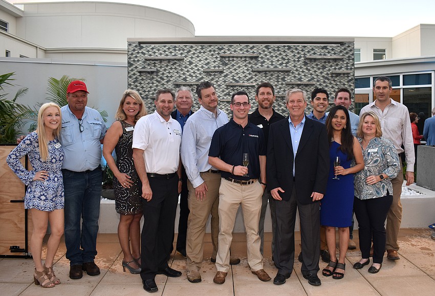 Willis Smith Construction employees pose for a photo following the ribbon cutting.
