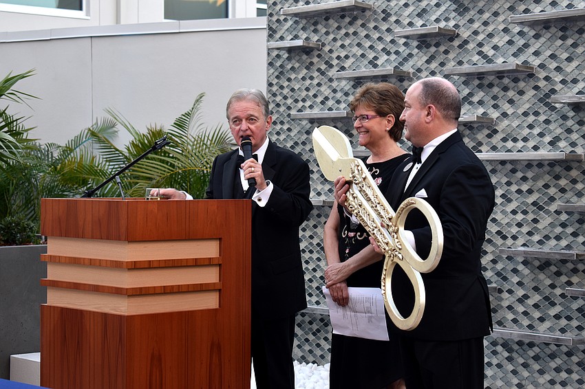 President and CEO of Plymouth Harbor Harry Hobson, Senior Vice President of Philanthropy Becky Pazkowski and Joe Devore give a toast before cutting the ribbon.