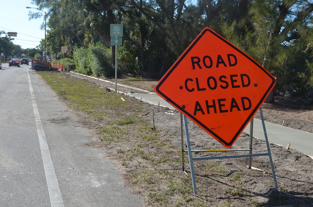 Work on the sidewalk has prompted a lane closure and contributed to traffic backups along westbound John Ringling Boulevard.