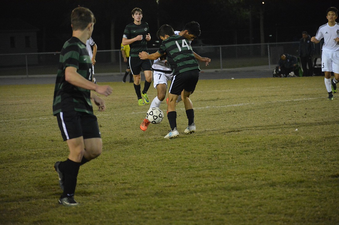 Sophomore defender Anthony Sablan bodies a Braden River forward and prevents him from advancing.