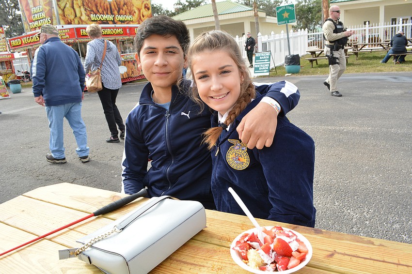 Lee Delatorre provides moral support to his friend Hayley O'Keefe, 15, who showed a swine with Lakewood Ranch High.
