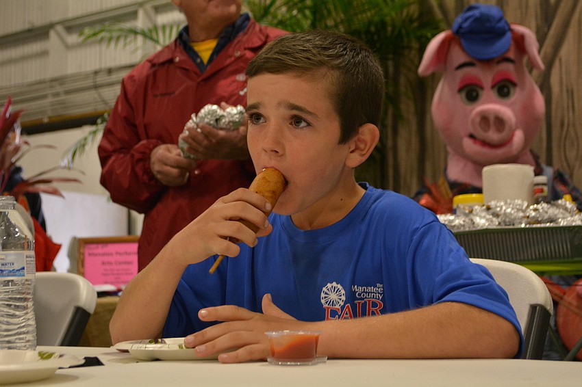 Myakka's Silas Stillman, 10, wins the corn dog eating contest for his age division, consuming almost three corn dogs.
