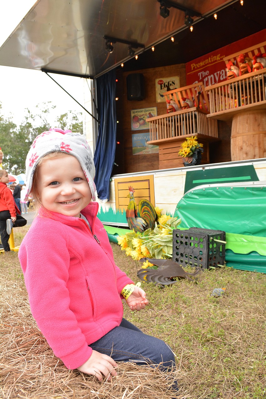 Gracyn Carpenter, 3, of Parrish,  readies to watch the Barnyard Chicken show.