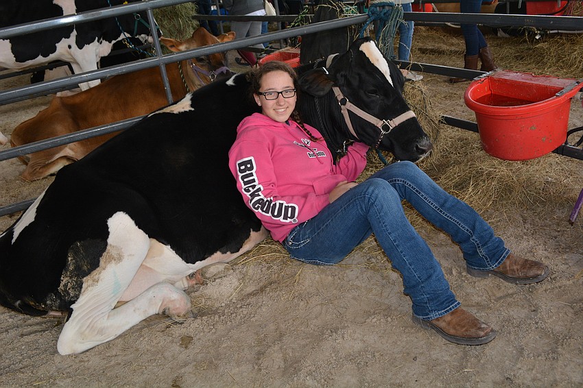 Nolan Middle School's Taylor Zwart, 13, snuggles with her heifer, Bessie.