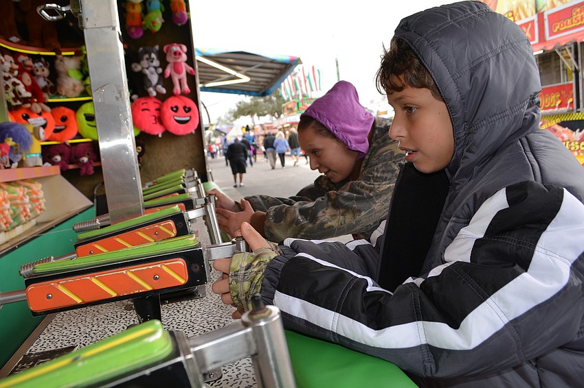 Kevin Thornton, 9, of Bradenton, beats his mom, Crystal in a Minion water shooting race.