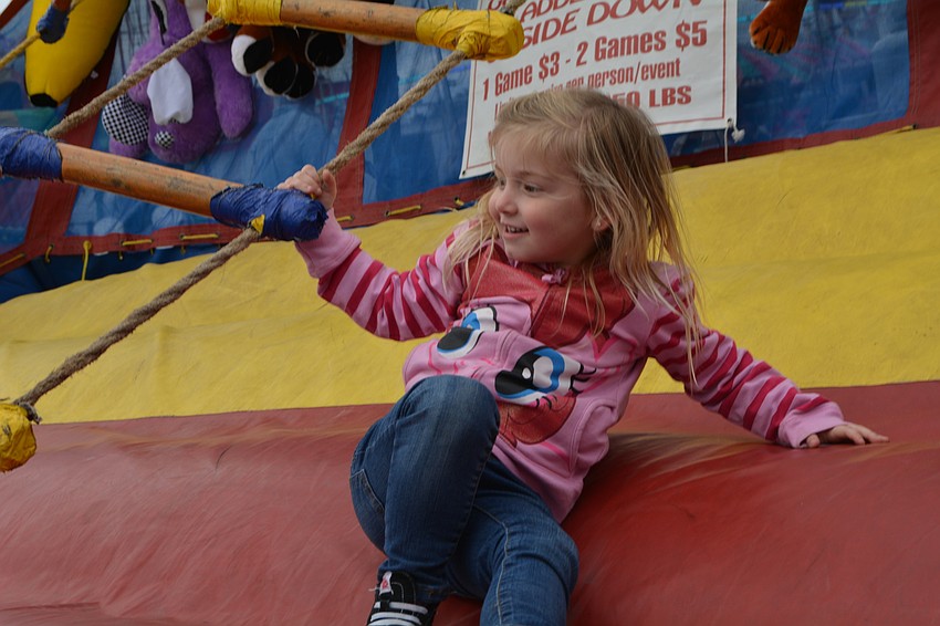 Peridia's Erika McNeill, 4, gives the lazy ladder challenge her all.