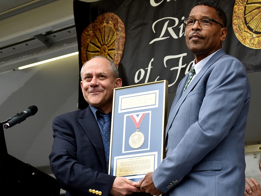 Master of Ceremonies Barry Lubin and inductee Cedric Walker