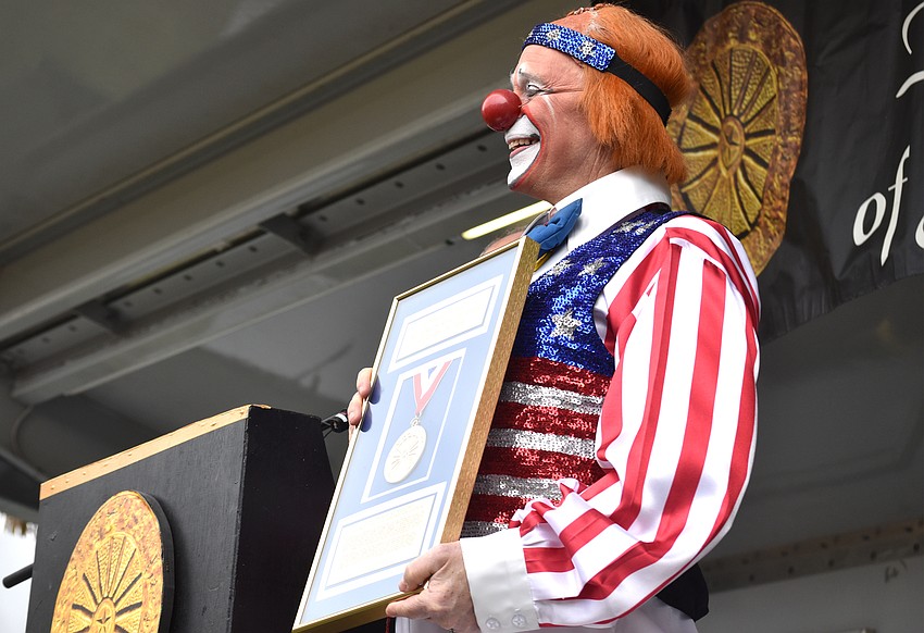 Chuck “Chucko” Sidlow holds his induction plaque up for the crowd to see.