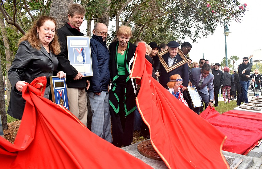 Inductees and their representatives reveal their plaques on the Circus Ring of Fame.
